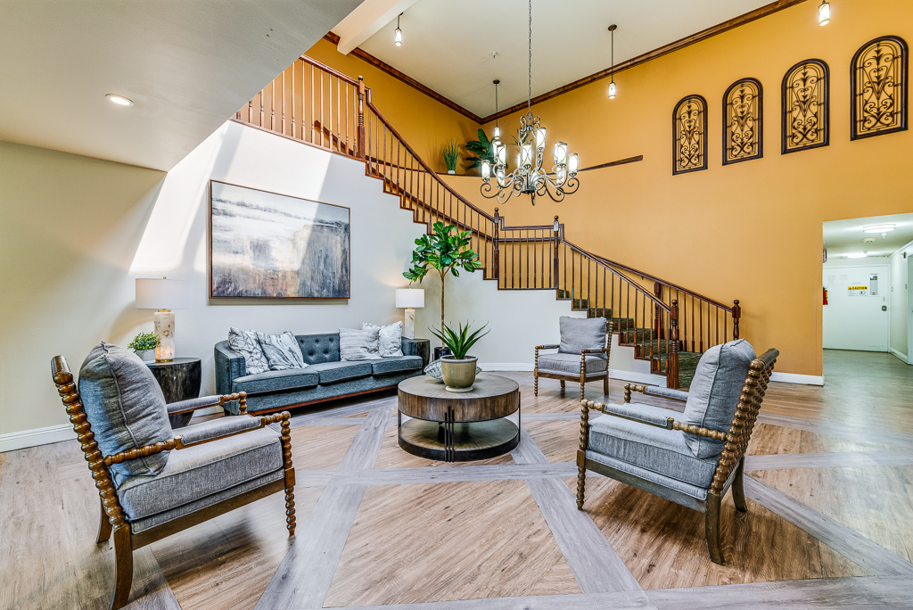arm chairs and a couch in front of a banister